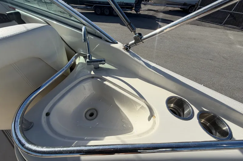 Slide: The Image of 2008 Sea Ray 240 Sundeck boat sink and cup holders in cockpit area. - 24