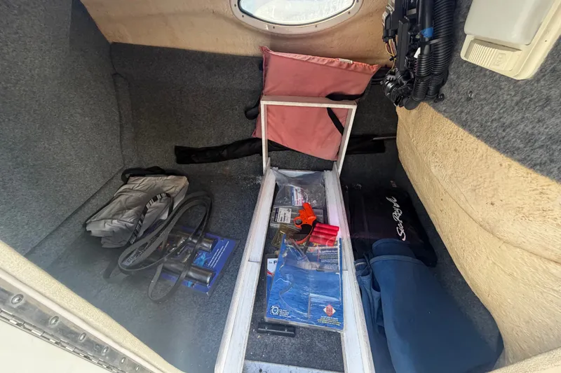 Slide: The Image of Storage compartment of a 2008 Sea Ray 240 Sundeck with boating accessories and equipment. - 50