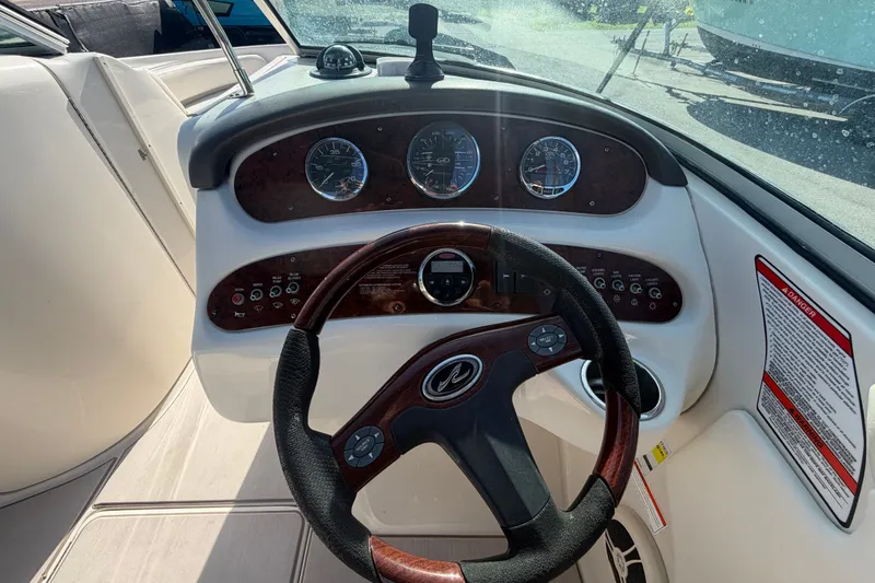 Slide: The Image of Steering console of a 2008 Sea Ray 240 Sundeck boat with gauges and controls. - 40