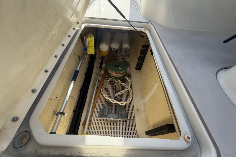 Slide: The Image of Storage compartment of a 2008 Sea Ray 240 Sundeck with cleaning tools and equipment. - 31