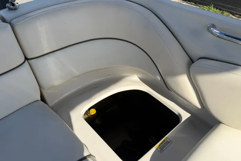 Slide: The Image of 2008 Sea Ray 240 Sundeck interior seating with storage compartment open. - 79