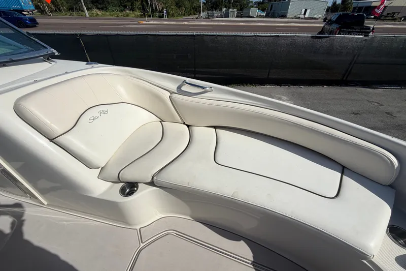 Slide: The Image of 2008 Sea Ray 240 Sundeck boat interior with white cushioned seating. - 64