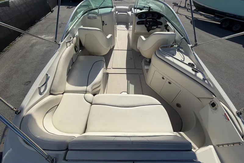 Slide: The Image of 2008 Sea Ray 240 Sundeck interior with spacious seating and helm, ideal for leisure boating. - 21