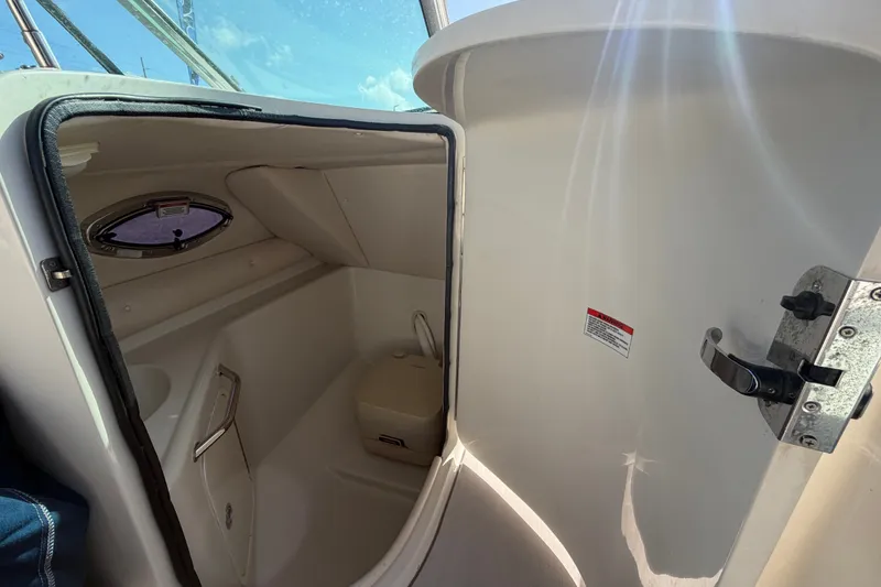 Slide: The Image of Interior view of 2008 Sea Ray 240 Sundeck boat's compact bathroom with window. - 35