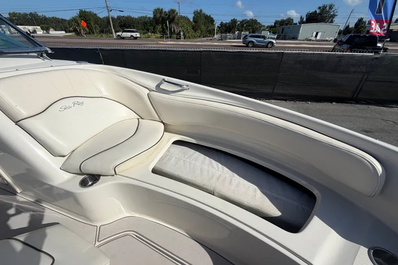 Slide: The Image of 2008 Sea Ray 240 Sundeck boat interior with white seating and cup holder. - 65