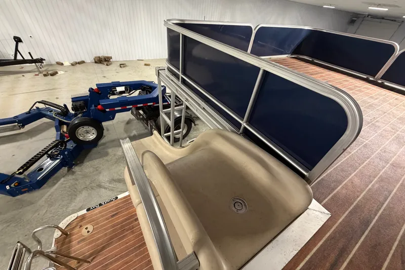 Slide: The Image of 2014 South Bay 526 CRUDS TRIPLE pontoon boat with slide and trailer in a garage. - 14