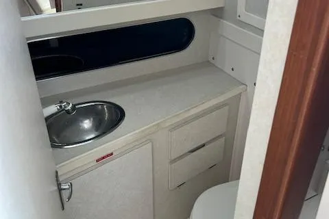 Slide: The Image of 1997 Blackfin 30.7 EXPRESS boat bathroom with sink and storage cabinets. - 25