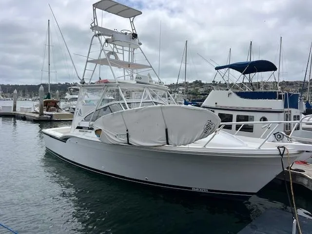 Slide: The Image of 1997 Blackfin 30.7 EXPRESS boat docked at marina with overcast sky. - 2