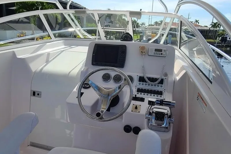 Slide: The Image of 2006 Pro-Line 28 Express boat cockpit with steering wheel and control panel. - 8