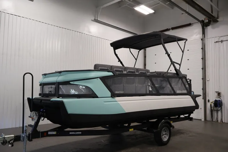 Slide: The Image of 2027 Sea-Doo Switch Cruise 21 pontoon boat in a garage setting. - 36