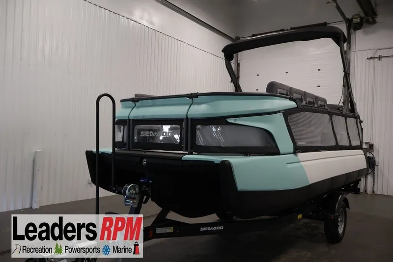 The Image of 2027 Sea-Doo Switch Cruise 21 pontoon boat in indoor showroom setting. - 2