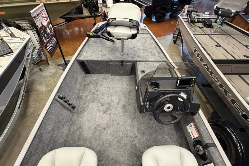 Slide: The Image of 2027 Tracker Bass Tracker Classic Limited boat interior with steering console and seating. - 40