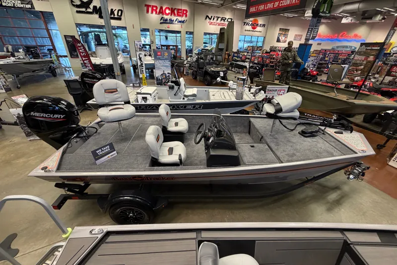 Slide: The Image of 2027 Tracker Bass Tracker Classic Limited boat displayed in showroom with Mercury engine. - 38