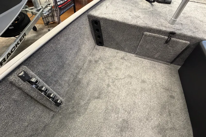 Slide: The Image of Interior of 2027 Tracker Bass Tracker Classic Limited boat with carpeted flooring and storage compartments. - 45