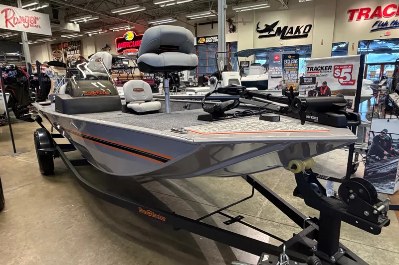 Slide: The Image of 2027 Tracker Bass Tracker Classic Limited boat displayed in a showroom with various marine equipment. - 39