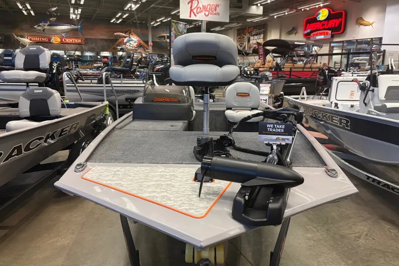 Slide: The Image of 2027 Tracker Bass Tracker Classic Limited boat displayed in a showroom with trade-in options. - 32