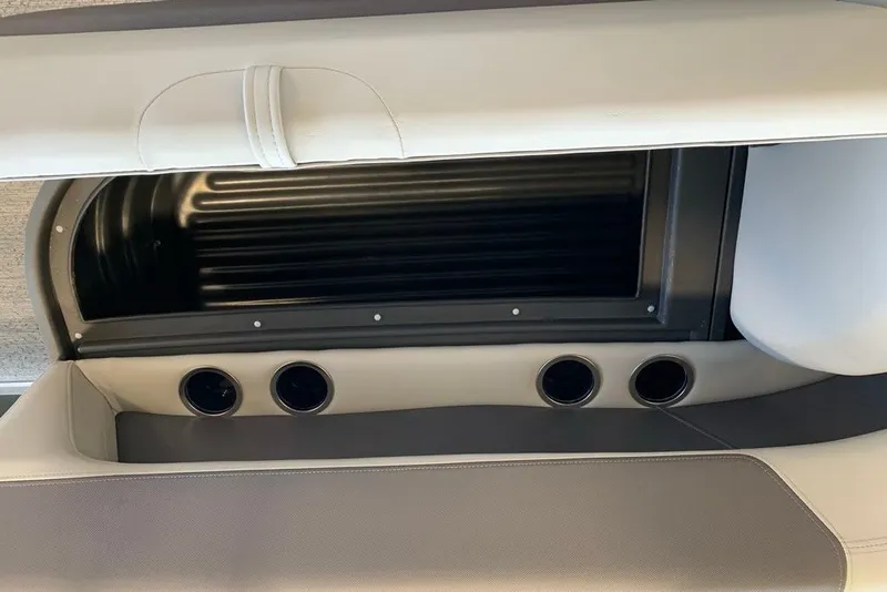 Slide: The Image of 2027 Sun Tracker Bass Buggy 16 XL Select interior storage compartment with cup holders. - 15