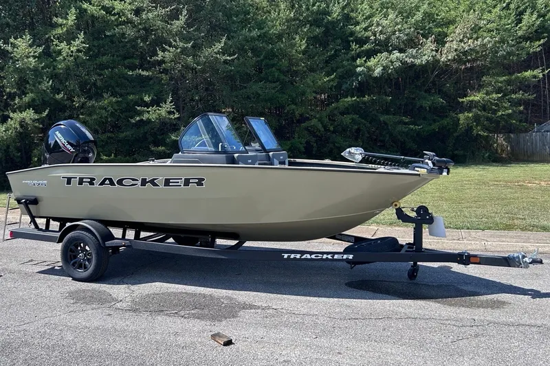 The Image of 2027 Tracker Pro Guide V-175 Combo boat on trailer, parked outdoors. - 0