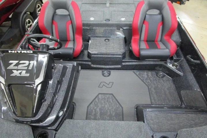 Slide: The Image of 2026 Nitro Z21 XL Pro boat interior with dual red and gray seats and steering console. - 10