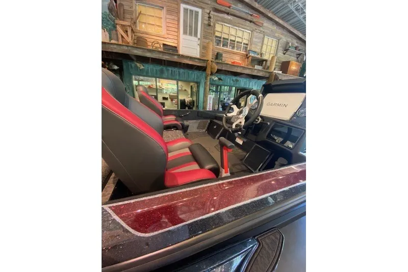 Slide: The Image of 2026 Nitro Z21 XL Pro boat interior with red and black seats, Garmin navigation system. - 7