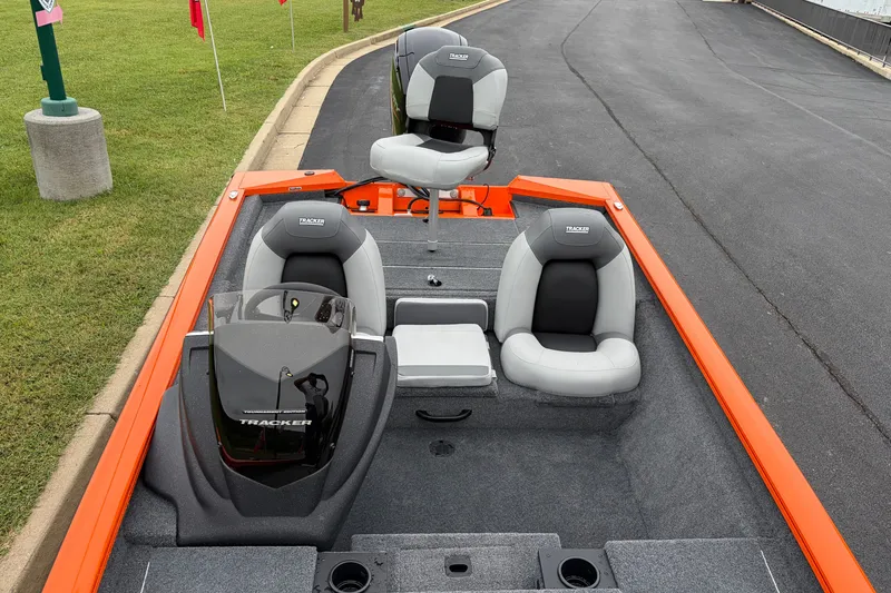 Slide: The Image of 2027 Tracker Pro Team 175 boat interior with gray seats and orange trim. - 16