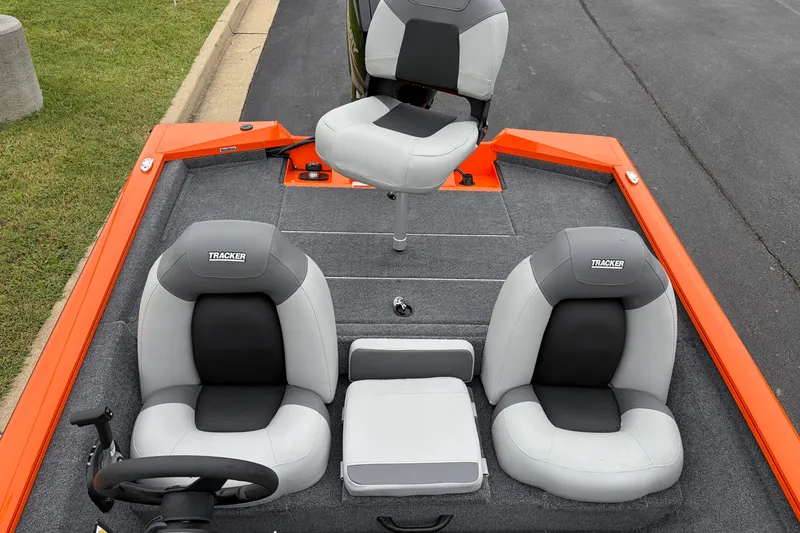 Slide: The Image of 2027 Tracker Pro Team 175 boat interior with gray seats and orange accents. - 17