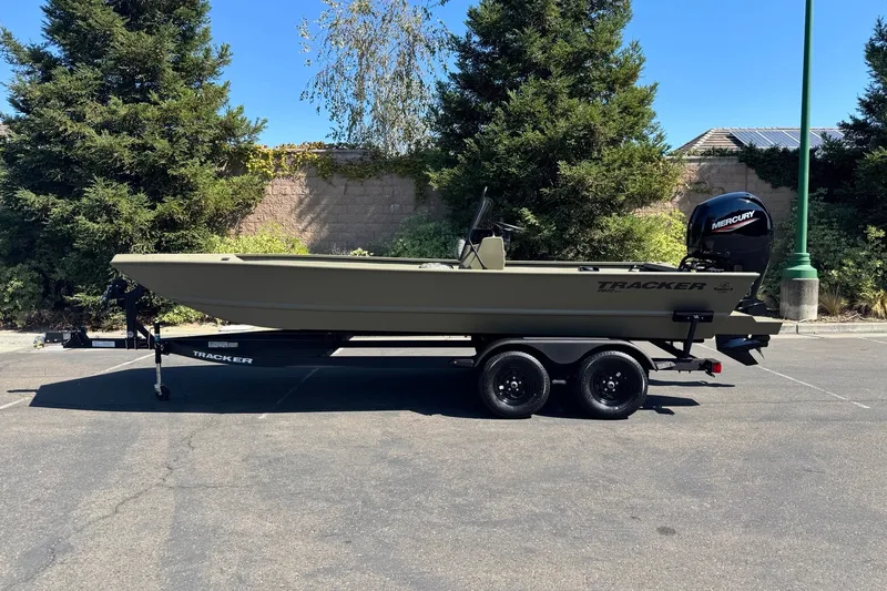 The Image of 2027 Tracker Grizzly 2072 CC boat on trailer, parked outdoors. - 0
