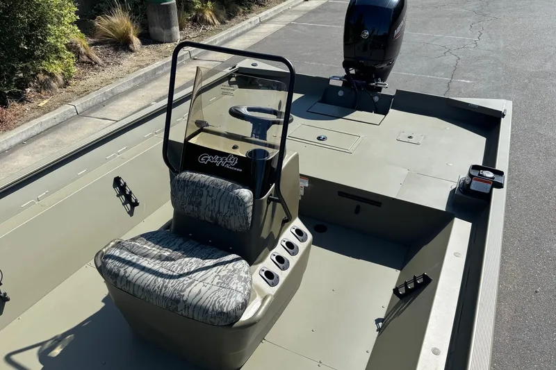 Slide: The Image of 2027 Tracker Grizzly 2072 CC boat with camouflage seating and center console. - 13