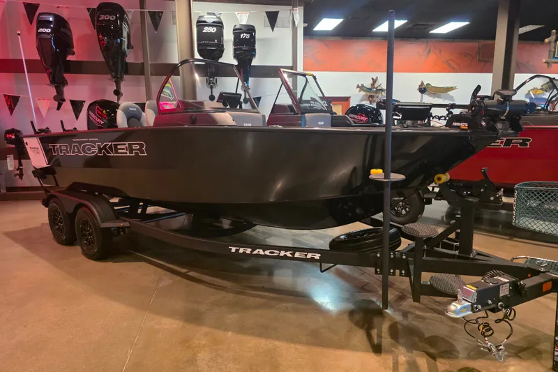 The Image of 2027 Tracker Targa V-18 Combo boat displayed indoors on a trailer. - 0