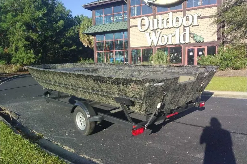 The Image of 2026 Tracker Grizzly 2072 Utility boat on trailer outside Outdoor World store. - 0