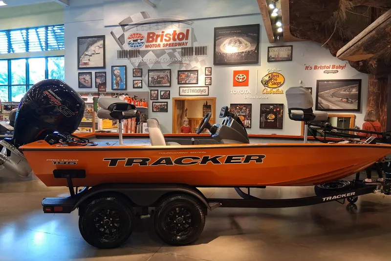 Slide: The Image of 2027 Tracker Pro Team 195 boat displayed indoors at Bristol Motor Speedway exhibit. - 13