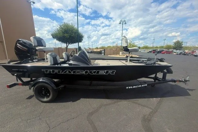 The Image of 2027 Tracker Pro 170 boat on trailer, parked outdoors under a cloudy sky. - 0