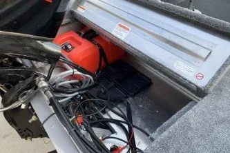 Slide: The Image of 2027 Tracker Super Guide V-16 SC boat interior with fuel tank and wiring. - 13