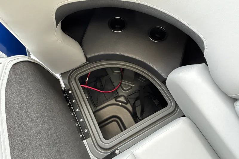 Slide: The Image of Storage compartment in 2027 Sun Tracker SportFish 20 DLX boat, featuring cup holders and wiring. - 37