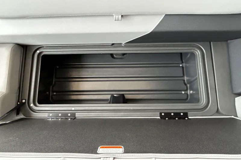 Slide: The Image of 2027 Sun Tracker SportFish 20 DLX storage compartment, open and empty, showcasing interior space. - 36