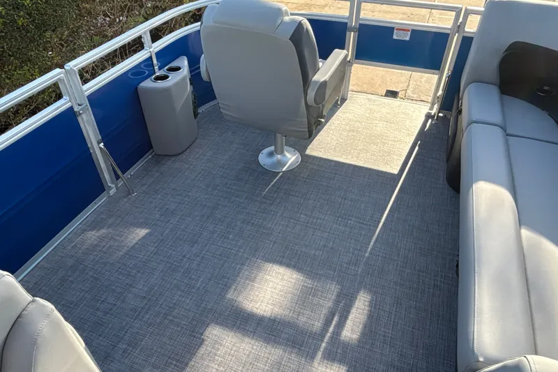 Slide: The Image of Interior of 2027 Sun Tracker SportFish 20 DLX pontoon boat with gray seating and flooring. - 18