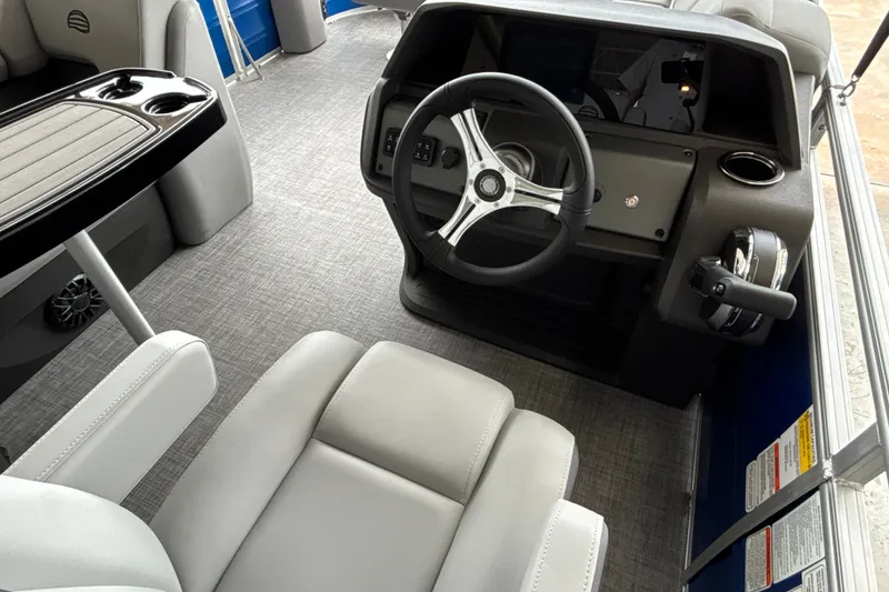 Slide: The Image of Interior view of 2027 Sun Tracker SportFish 20 DLX boat, featuring steering wheel and seating. - 22