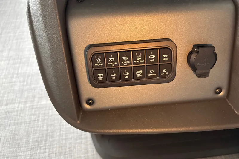 Slide: The Image of Control panel of 2027 Sun Tracker SportFish 20 DLX boat with various switches. - 25
