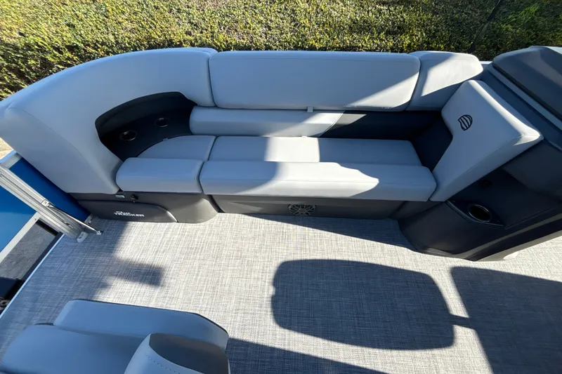 Slide: The Image of 2027 Sun Tracker SportFish 20 DLX boat interior with gray seating and cup holders. - 17
