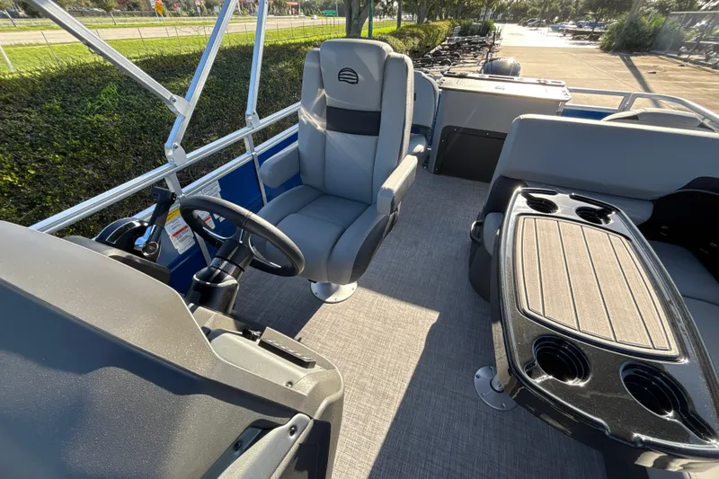 Slide: The Image of 2027 Sun Tracker SportFish 20 DLX interior with steering wheel and seating area. - 20