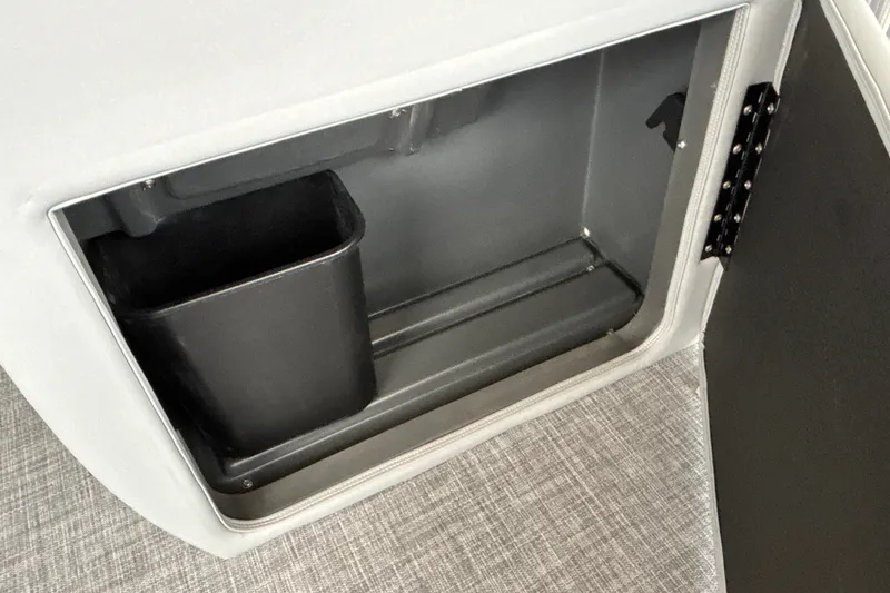 Slide: The Image of Storage compartment of 2027 Sun Tracker SportFish 20 DLX with integrated trash bin. - 34