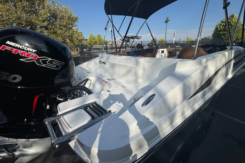 Slide: The Image of 2027 Tahoe 1950 boat with Mercury Pro XS engine, parked outdoors. - 8