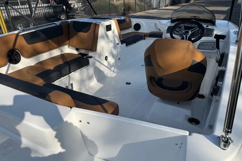 Slide: The Image of 2027 Tahoe 1950 boat interior with brown and black seating, modern steering console. - 7