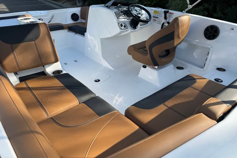 Slide: The Image of Luxurious interior of 2027 Tahoe 1950 boat with brown leather seating and modern dashboard. - 11