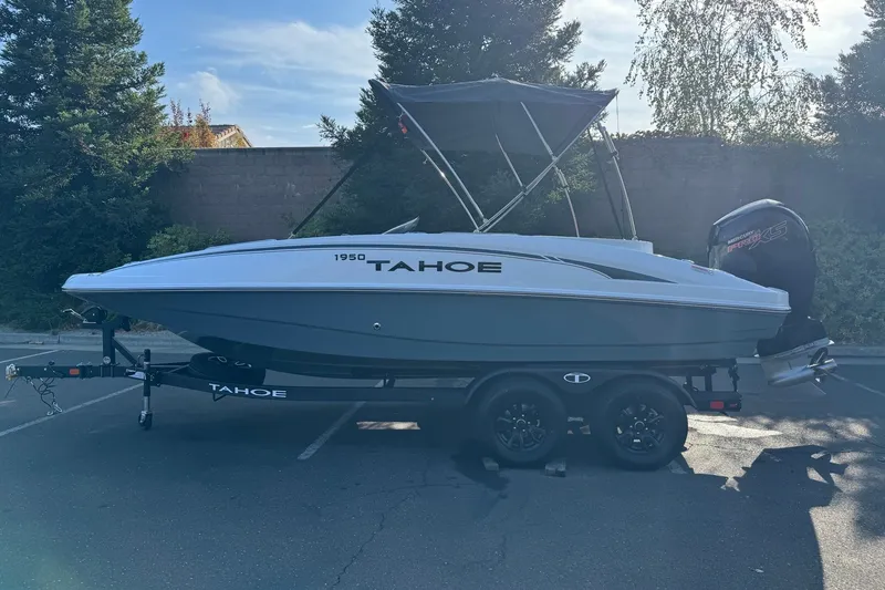 The Image of 2027 Tahoe 1950 boat with canopy on trailer in parking lot. - 0