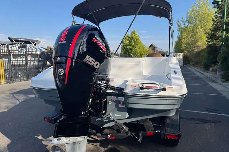 Slide: The Image of 2027 Tahoe 1950 boat with Mercury 150 engine, parked outdoors. - 6