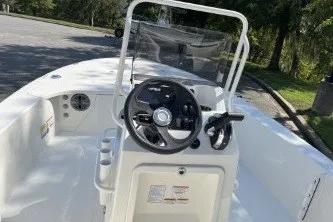 Slide: The Image of 2026 Mako 18 Pro Skiff boat interior with steering console and seating. - 18