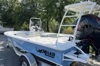 Slide: The Image of 2026 Mako 18 Pro Skiff boat on trailer, outdoors with trees in background. - 9