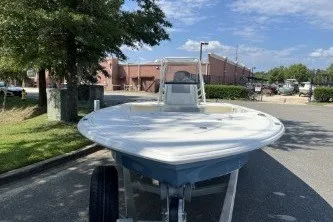 Slide: The Image of 2026 Mako 18 Pro Skiff boat on trailer in sunny outdoor setting. - 2