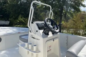 Slide: The Image of 2026 Mako 18 Pro Skiff boat console with steering wheel and cup holders. - 8